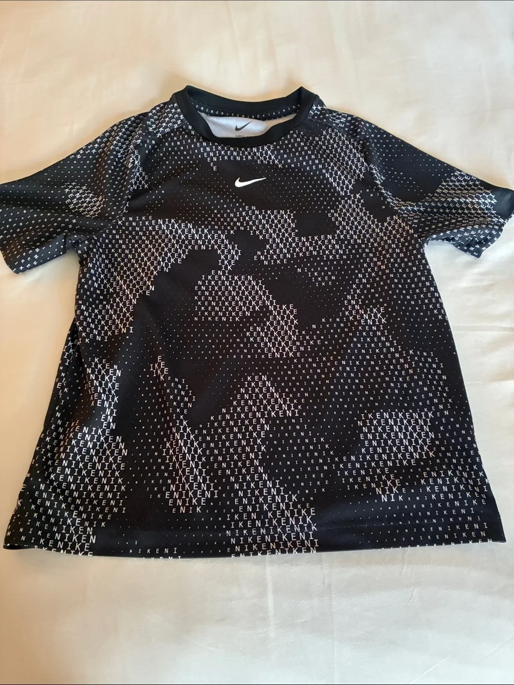 Nike Black Tee with White Micro-Text and Swoosh